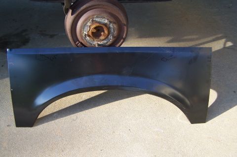 1990 Ford Bronco - Sheet metal fender repair panel shown with a brake rotor in the background.