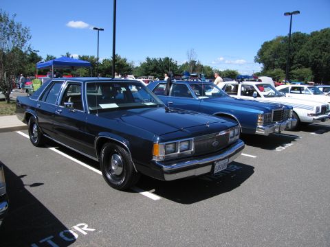 1991 Ford LTD Crown Victoria - dark blue Ford LTD Crown Victoria sedan parked among other classic sedans at an outdoor car show.