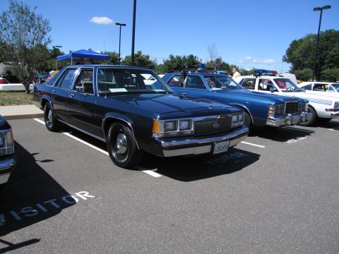 1991 Ford LTD Crown Victoria - dark blue Ford LTD Crown Victoria sedan parked in a marked lot at a car show on a sunny day.