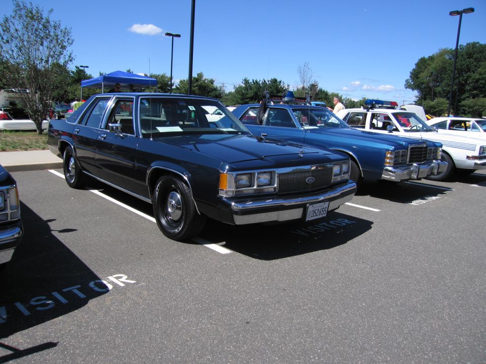 Blue Ford LTD Crown Victoria four-door sedan in a parking lot