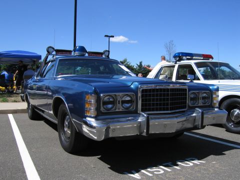 1991 Ford LTD Crown Victoria - blue 1970s Ford LTD outfitted as a police car with roof spotlight and emergency lights at a show.