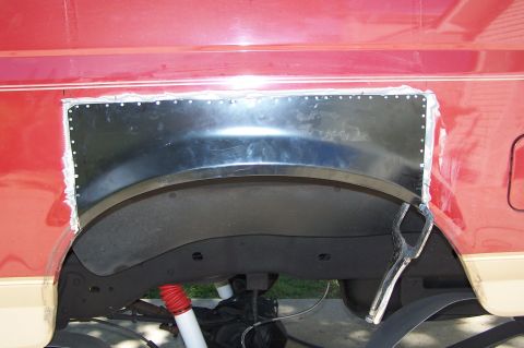 1990 Ford Bronco - Custom metal patch is installed in the rear wheel well of a red 1990 Ford Bronco.
