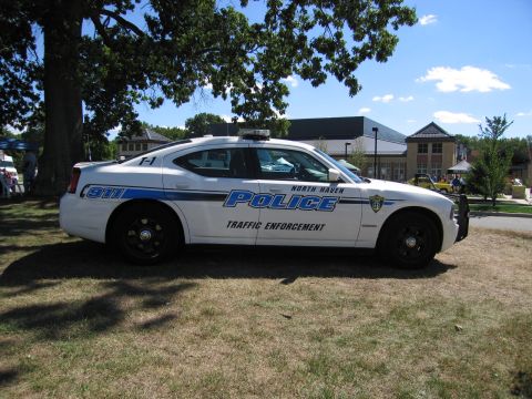 1991 Ford LTD Crown Victoria - Side view of a white North Haven Police Dodge Charger marked Traffic Enforcement parked on grass.