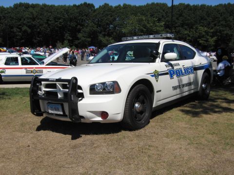 1991 Ford LTD Crown Victoria - Front-quarter view of a white North Haven Police Dodge Charger with a push bar and roof light bar.