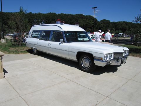 1991 Ford LTD Crown Victoria - Front-quarter view of a white vintage Cadillac ambulance with roof beacons parked on pavement at a show.