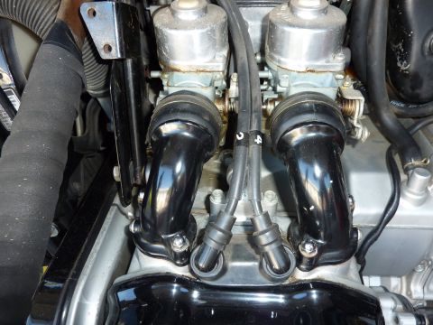 1978 Honda GL1000 - Close-up view of a motorcycle's engine, focusing on the dual carburetors and spark plug wires.