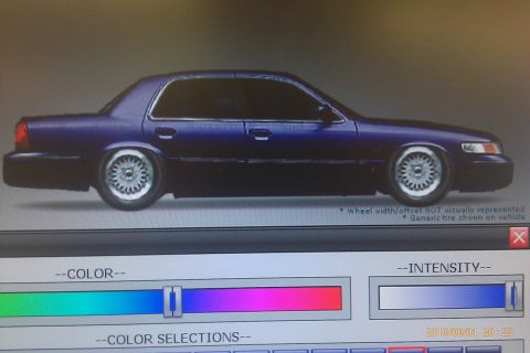 2000 Mercury Grand Marquis - A side profile of a sedan is displayed on a screen with color and intensity adjustment sliders below.