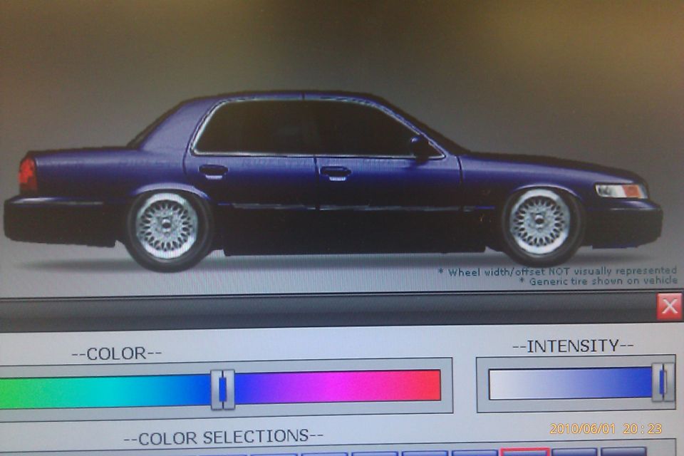 Dark blue sedan with custom wheels, possibly a Mercury Grand Marquis, shown on a computer screen with color selection tools