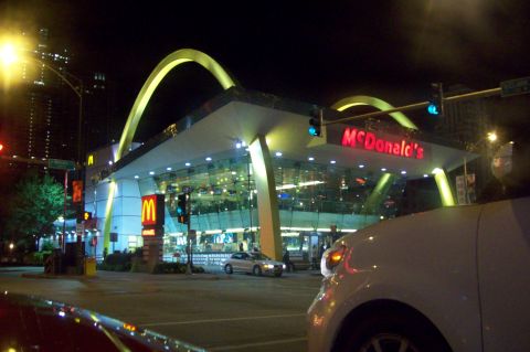 1998 Dodge Viper - A McDonald's restaurant is illuminated at night, with cars visible in the foreground and on the street.
