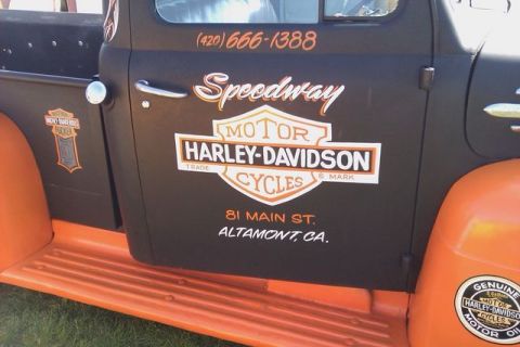 1991 Ford Crown Victoria - Vintage pickup truck door displays Speedway Harley-Davidson Cycles branding and contact information.