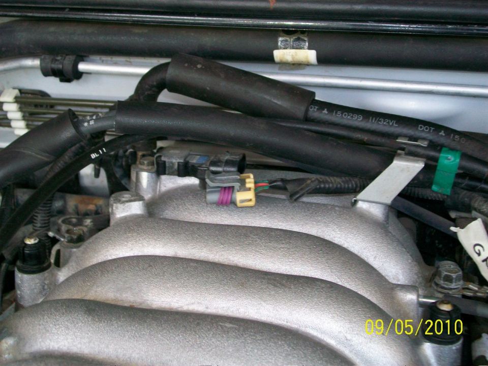 close-up of engine intake manifold with hoses and connectors