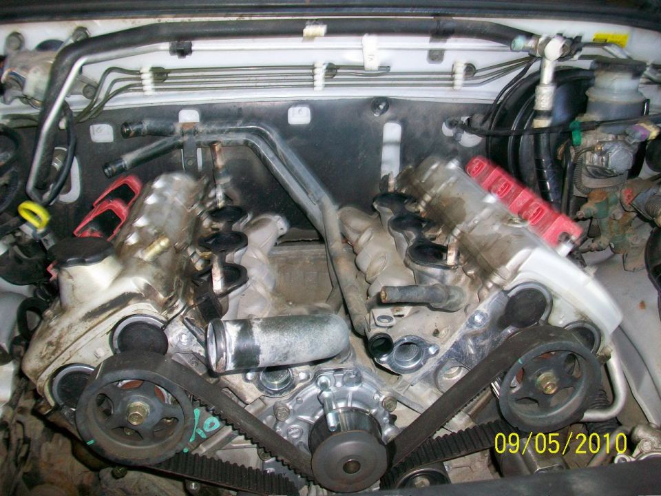 Engine bay with V6 engine components and timing belt