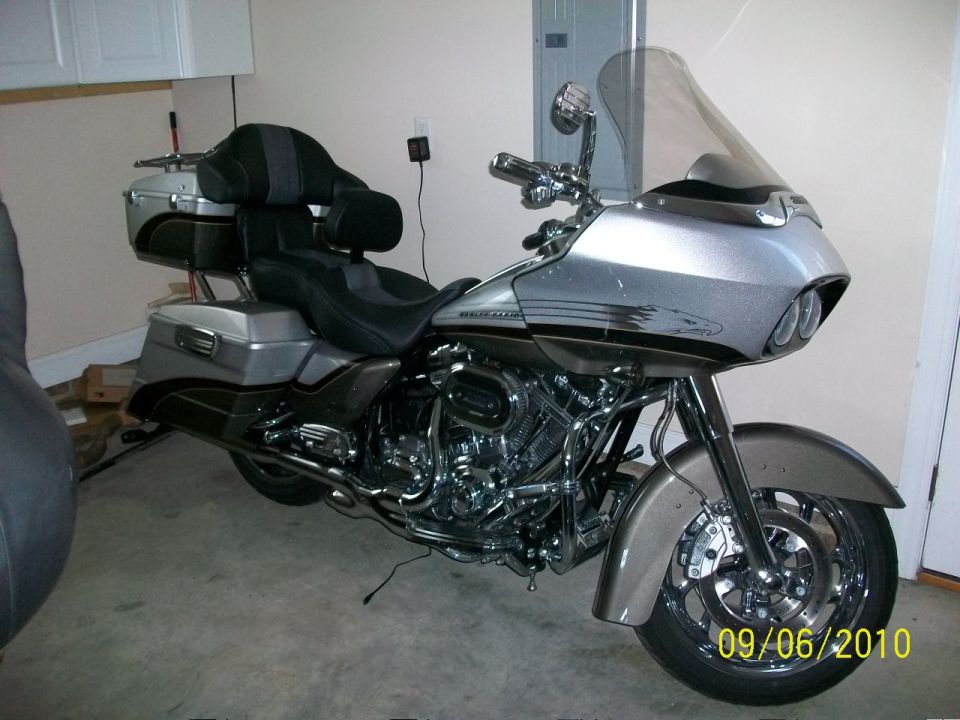 Silver motorcycle with large windshield and dual headlights