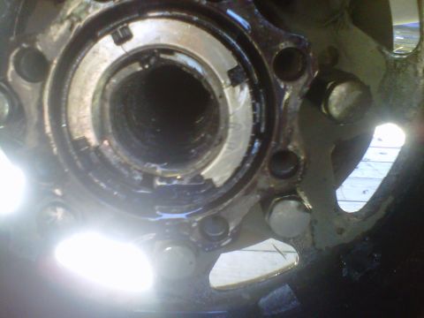 1992 Ford F-350 - A close-up view of a vehicle's wheel hub assembly, showing the lug nut mounting points.
