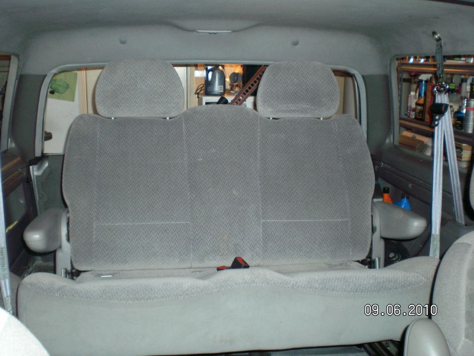 Gray cloth rear bench seat with headrests viewed from the rear cargo opening