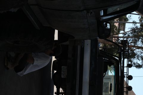 1992 Ford Bronco - A person works on the underside of a vehicle, with a license plate reading "29CU362" visible.
