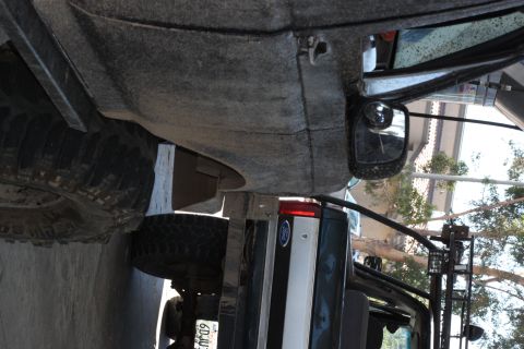 1992 Ford Bronco - A close-up view of the rear of a dirty Ford truck, with a spare tire mounted underneath.