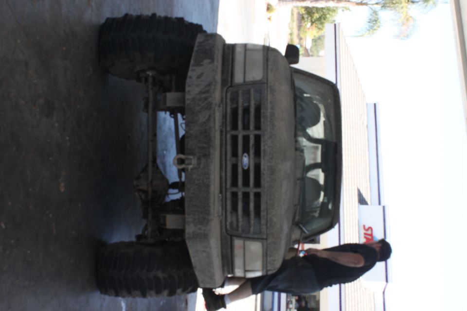 Mud-covered 1992 Ford Bronco front view, lifted with large tires