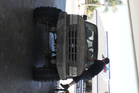 1992 Ford Bronco - Front view of a 1992 Ford Bronco with a person leaning on the hood.