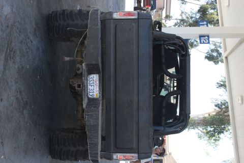 1992 Ford Bronco - This 1992 Ford Bronco is seen from the rear, oversized tires and a roll cage.