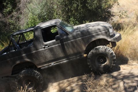 1992 Ford Bronco - This 1992 Ford Bronco is navigating a dusty, off-road trail.