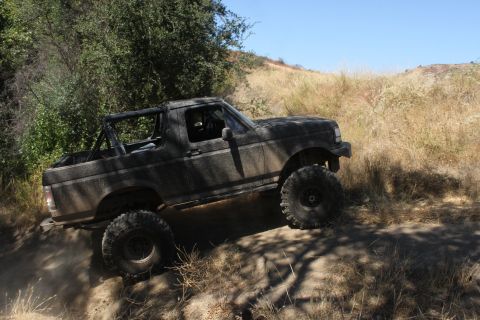 1992 Ford Bronco - Modified 1992 Ford Bronco tackling an off-road trail.