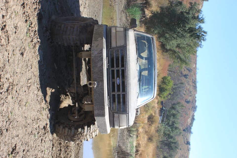 1992 Ford Bronco with custom bumper and large tires in mud