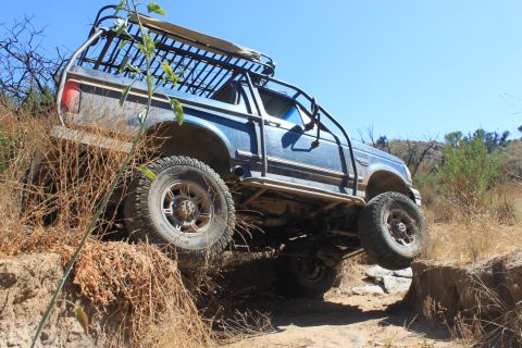1992 Ford Bronco - This 1992 Ford Bronco is navigating a challenging off-road obstacle.