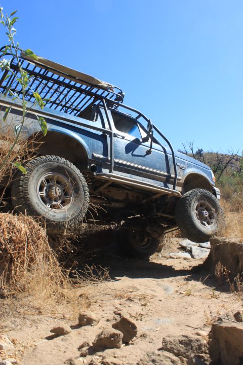 1992 Ford Bronco - This 1992 Ford Bronco navigates a challenging off-road trail with one wheel in the air.