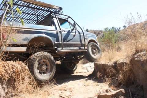 1992 Ford Bronco - This 1992 Ford Bronco is navigating a challenging off-road obstacle.