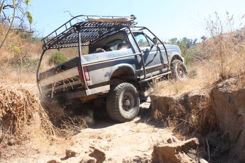 1992 Ford Bronco - Modified 1992 Ford Bronco navigating a challenging off-road trail.