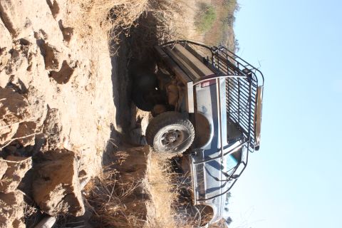 1992 Ford Bronco - A vehicle is stuck in a dirt embankment, tilted precariously.