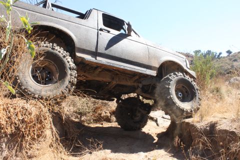 1992 Ford Bronco - This 1992 Ford Bronco is navigating a challenging off-road course with steep inclines and rocky terrain.