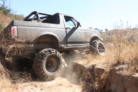 1992 Ford Bronco - This 1992 Ford Bronco is shown off-roading on a dusty, dry trail.