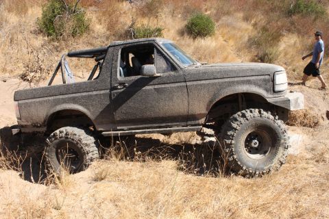 1992 Ford Bronco - This heavily modified 1992 Ford Bronco navigates a challenging off-road trail.