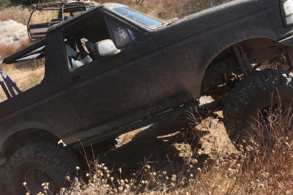 Black 1992 Ford Bronco on a rocky trail