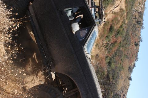 1992 Ford Bronco - Muddy 1992 Ford Bronco navigating a challenging off-road trail.