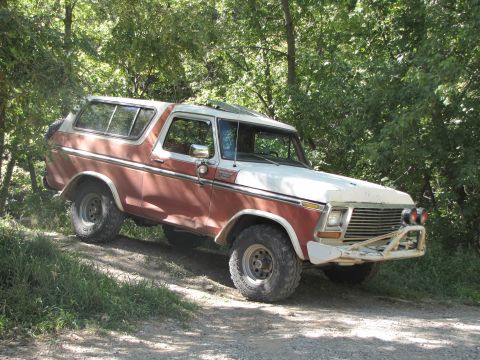 1978 Ford Bronco - This two-tone Bronco is navigating a wooded trail.