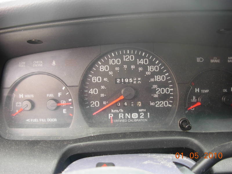 Car dashboard with speedometer, odometer, fuel gauge, and temperature gauge. Odometer reads 21952
