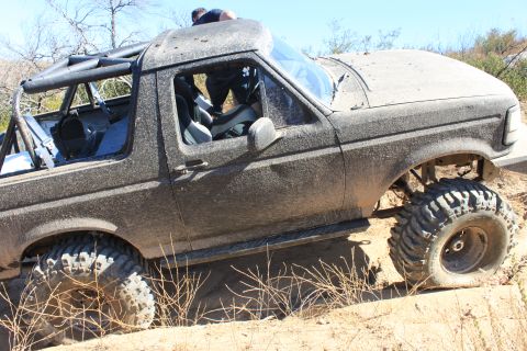 1992 Ford Bronco - This heavily modified 1992 Ford Bronco is shown navigating a challenging off-road course.