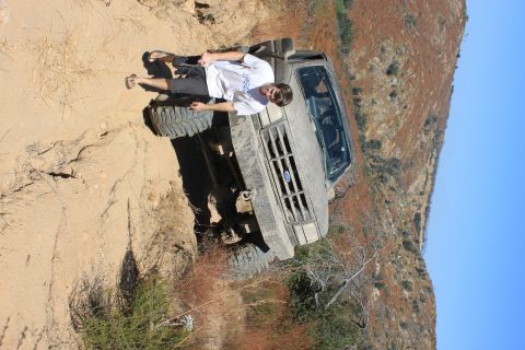 1992 Ford Bronco - A 1992 Ford Bronco is seen on a dirt trail with a person standing next to it.
