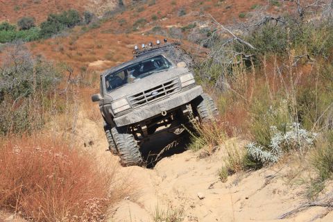 1992 Ford Bronco - This 1992 Ford Bronco navigates a steep, sandy trail, its off-road capabilities.