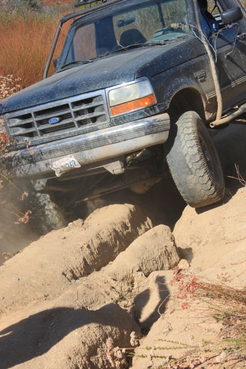 1992 Ford Bronco - Ford Bronco navigating rough terrain on an off-road trail.