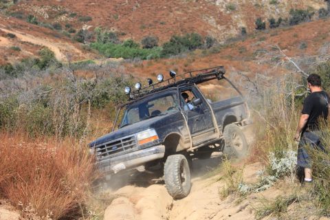 1992 Ford Bronco - Off-road adventure in a 1992 Ford Bronco on a challenging dirt path.