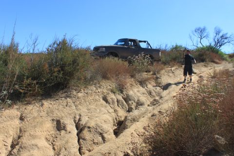 1992 Ford Bronco - A 1992 Ford Bronco is parked on a dirt hill with a man standing behind it.