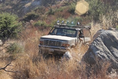 1992 Ford Bronco - A 1992 Ford Bronco navigates a , off-road path.