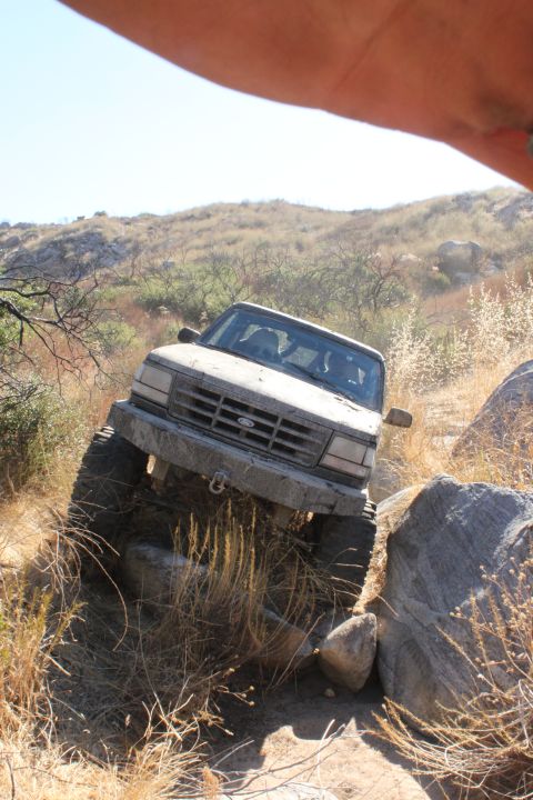 1992 Ford Bronco - This 1992 Ford Bronco is shown tackling a challenging off-road trail with large rocks.