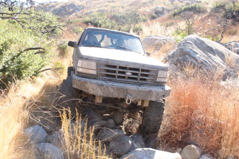1992 Ford Bronco - This 1992 Ford Bronco tackles a challenging rocky trail, demonstrating its off-road capabilities.