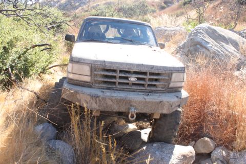 1992 Ford Bronco - This 1992 Ford Bronco is shown off-roading through a rocky, dry landscape.