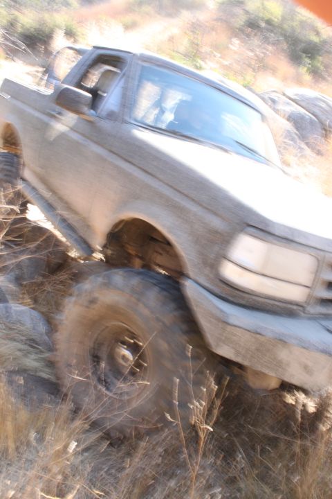1992 Ford Bronco - A 1992 Ford Bronco navigates a rocky, off-road trail.